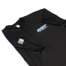 Load image into Gallery viewer, Front view of a motorsports tee laid flat in black